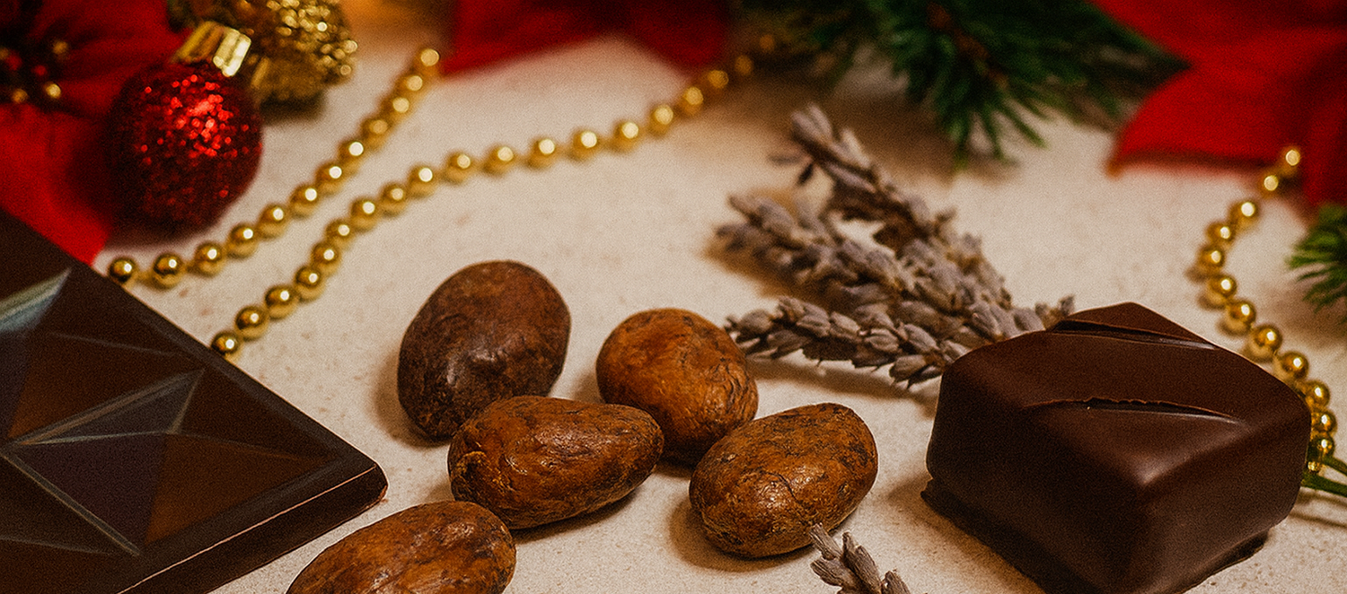 Chocolate pieces and cacao beans on a decorative surface with gold beads and lavender.